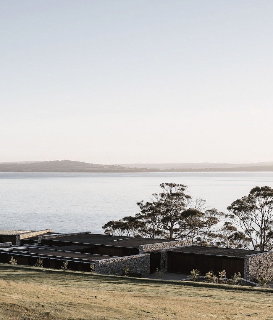 A cliffside home of wood and stone at one with the Tasmanian landscape