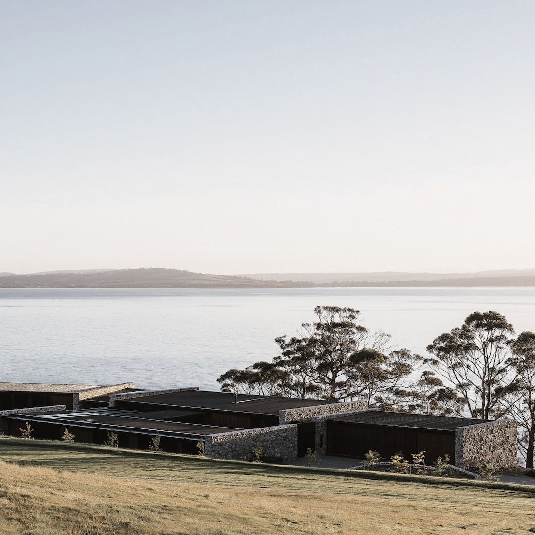 A cliffside home of wood and stone at one with the Tasmanian landscape