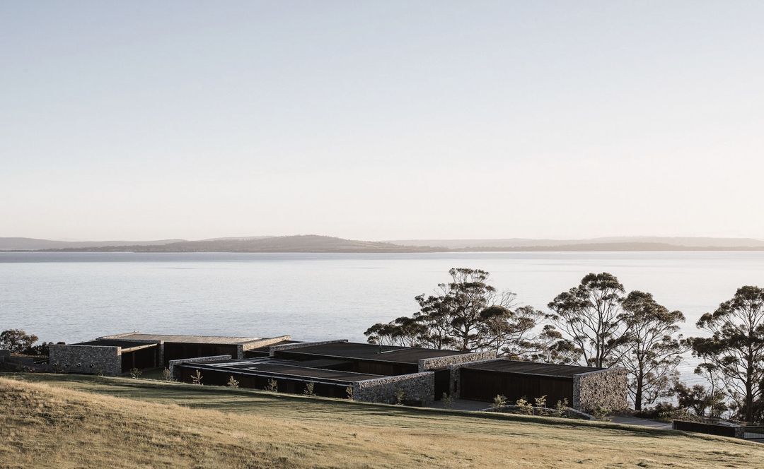A cliffside home of wood and stone at one with the Tasmanian landscape