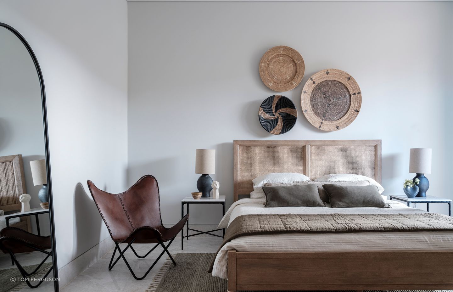 Studio LHD engaged the craftsmanship of talented artisans and local suppliers for this project. In this bedroom, the wall-mounted baskets from a store in Gerringong are textural and fit perfectly with the materiality of the space.