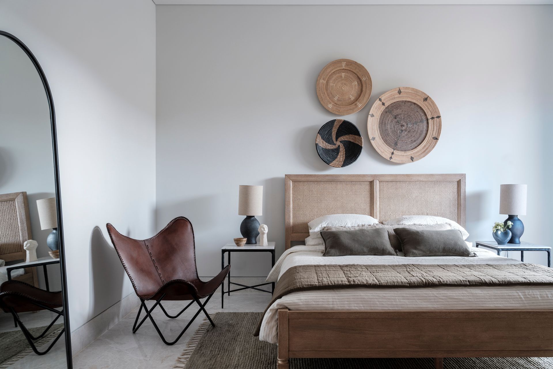 Studio LHD engaged the craftsmanship of talented artisans and local suppliers for this project. In this bedroom, the wall-mounted baskets from a store in Gerringong are textural and fit perfectly with the materiality of the space.