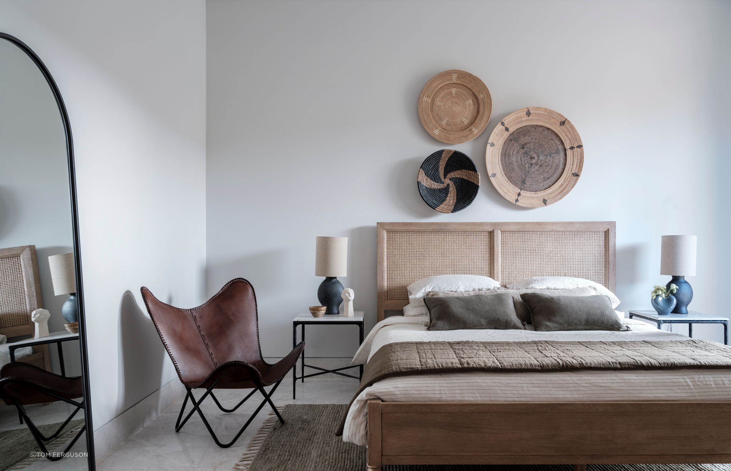 Studio LHD engaged the craftsmanship of talented artisans and local suppliers for this project. In this bedroom, the wall-mounted baskets from a store in Gerringong are textural and fit perfectly with the materiality of the space.