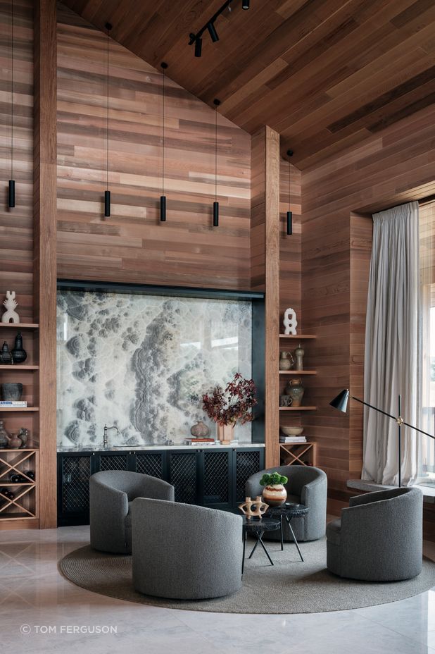 Onyx natural stone makes a statement in the bar area. The bench has a sink for easy access and cabinetry provides plenty of storage.