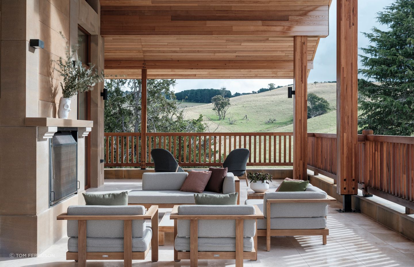 The two metre-wide sandstone outdoor fireplace mirrors the indoor fireplace.