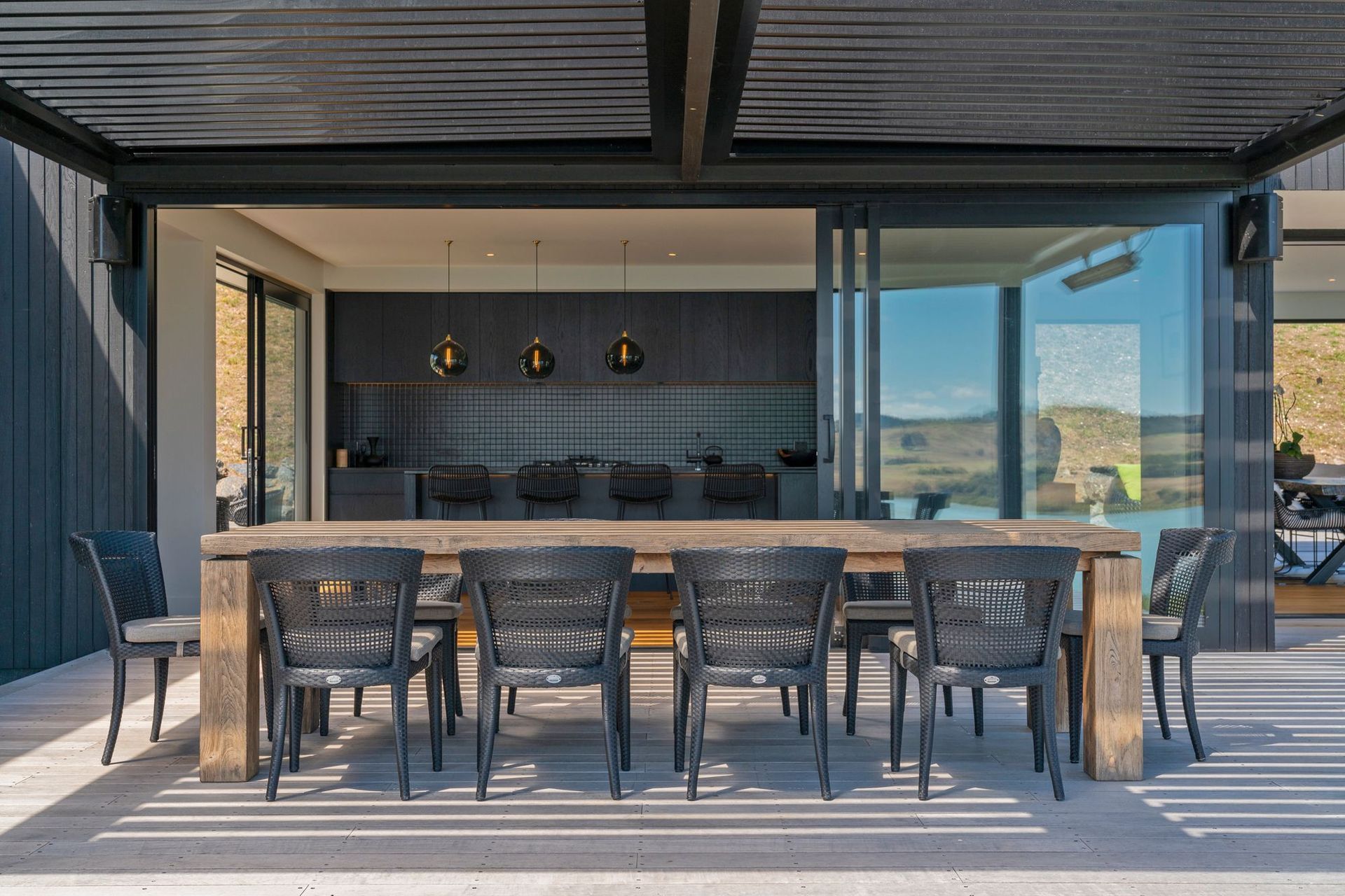 The open-plan kitchen, living and dining area opens out onto decking, complete with a louvre roof.