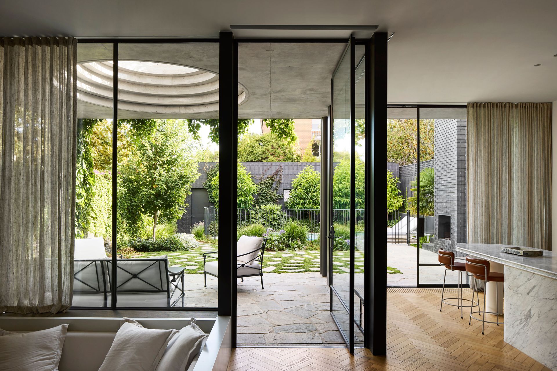 The new extension directly connects the kitchen and living spaces to an outdoor patio.