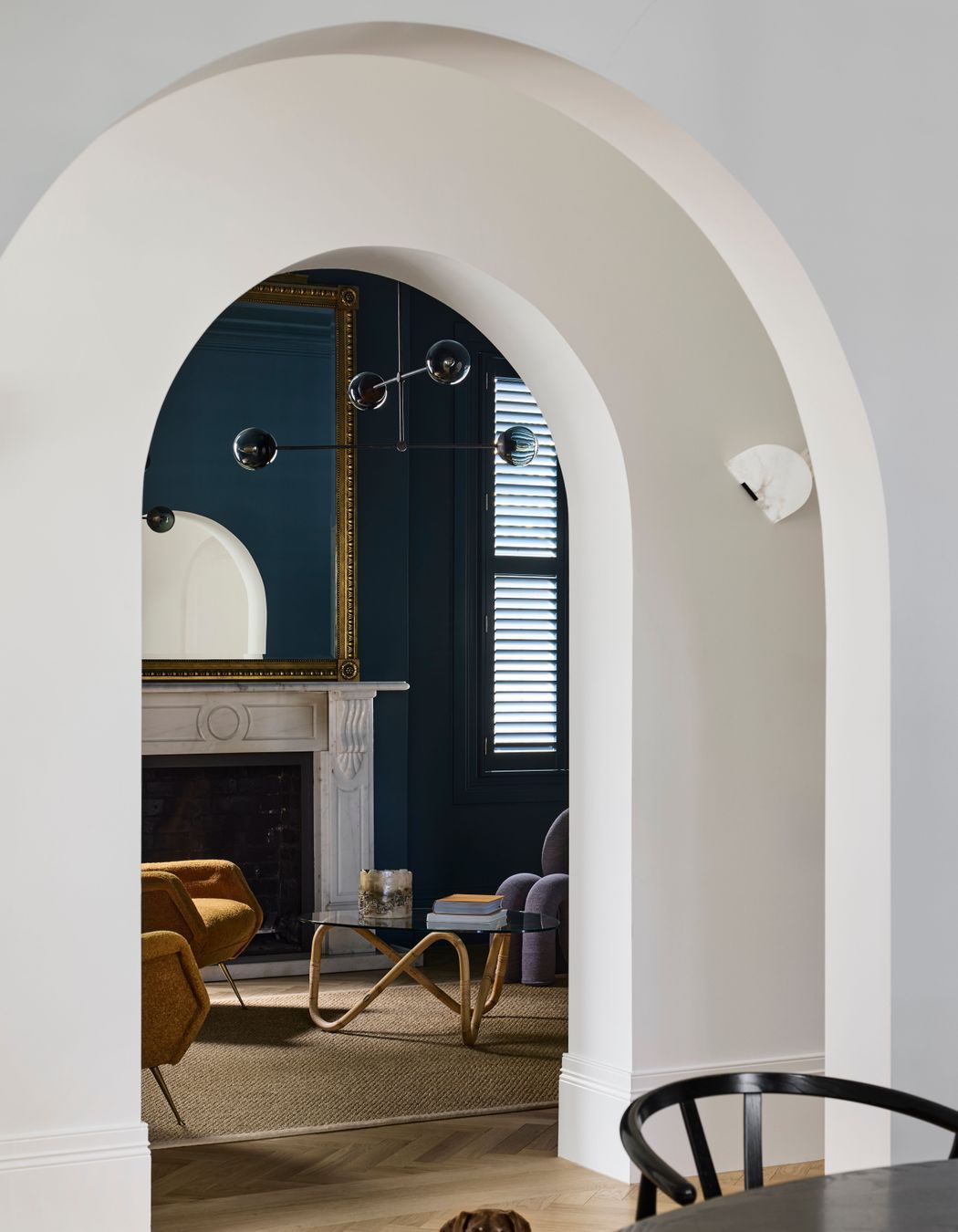 Arched openings from the hallway to the living spaces.