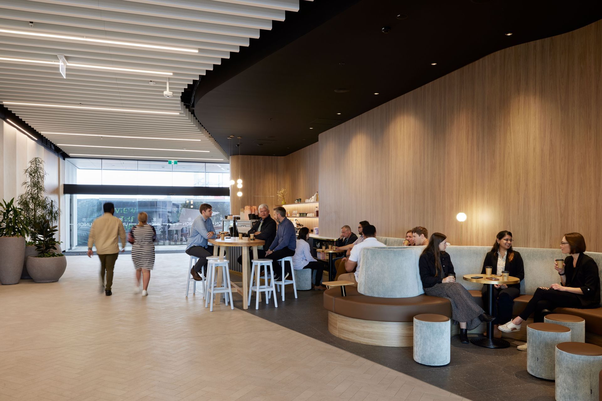 “The intent was to give the lobby and courtyard a bit of a laneway aesthetic. That’s why we’ve got the small herringbone paver tiles, running through that precast concrete from outside, and it’s glazed to have a visual link and natural light coming into that space.”