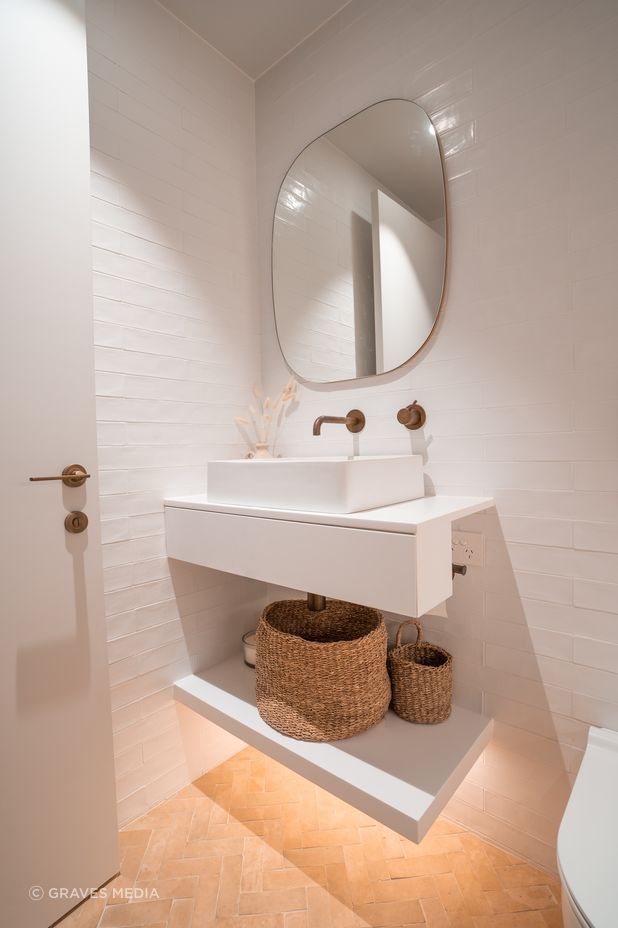 Handmade terracotta floor tiles bring warms and texture to the master ensuite.