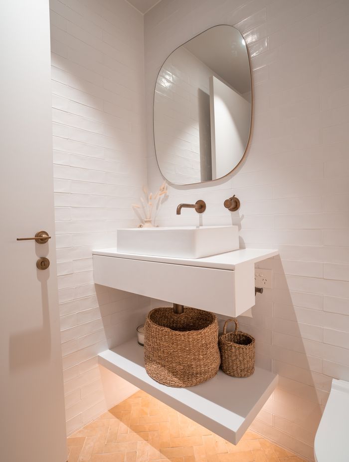 Handmade terracotta floor tiles bring warms and texture to the master ensuite.