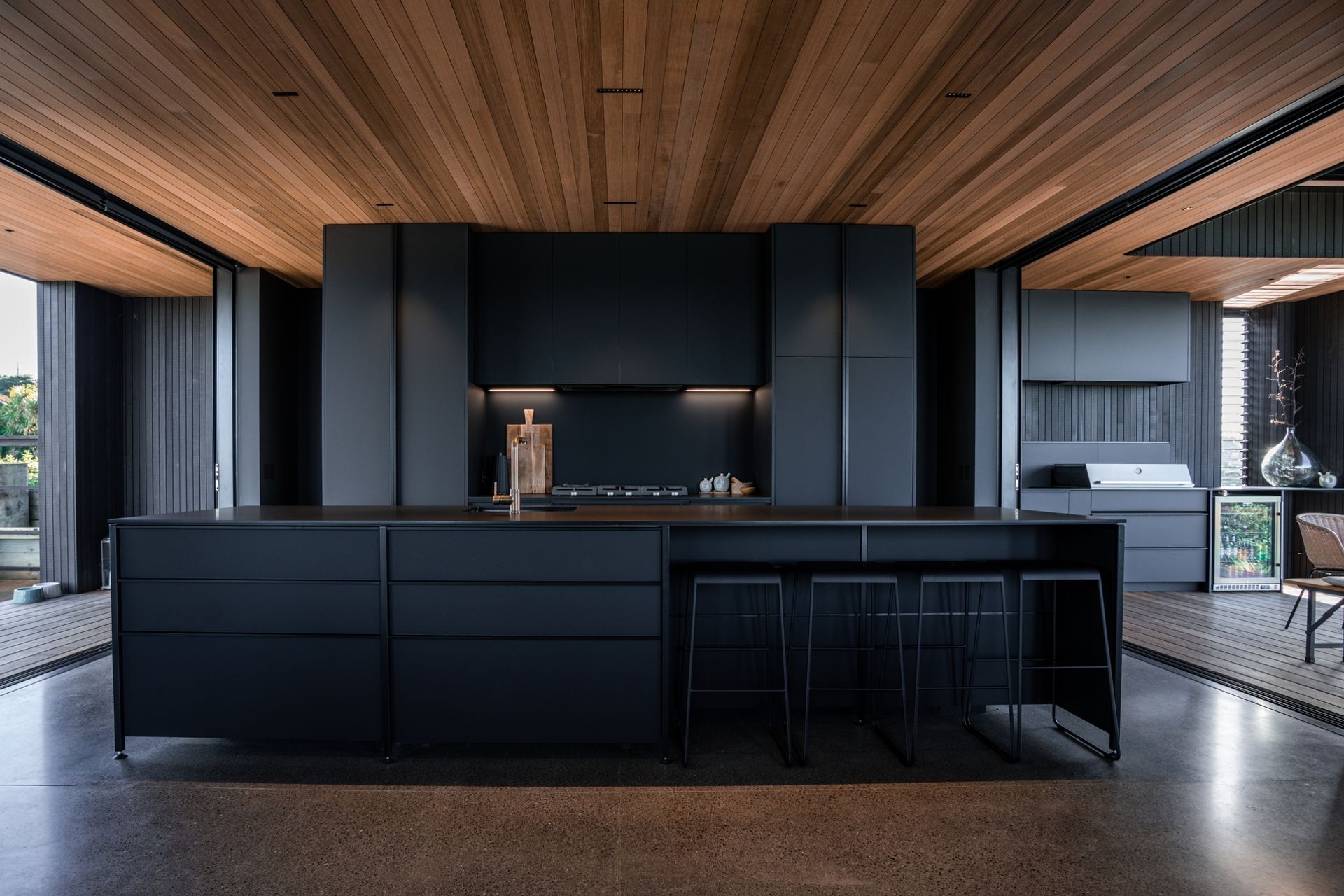 The island bench features an integrated sink and plenty of space for the family to gather around.