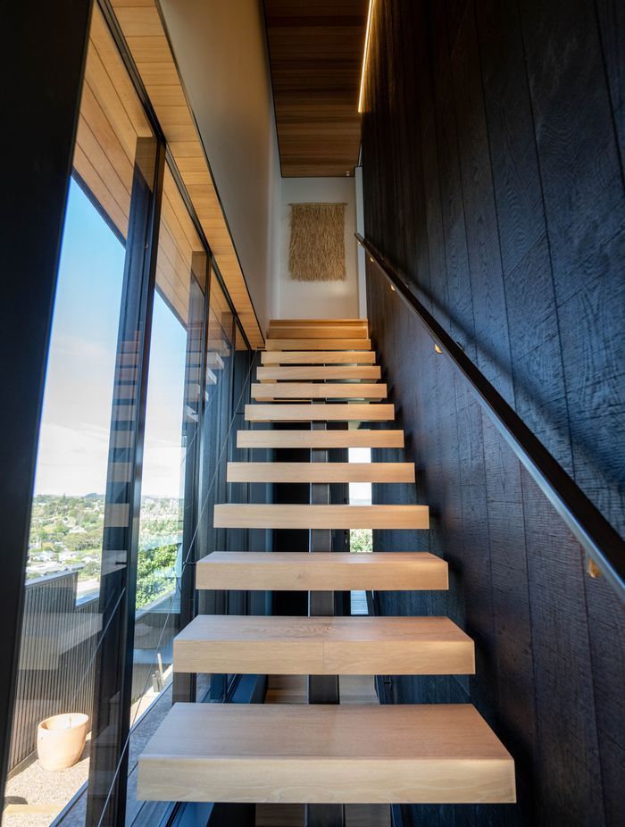 Floating oak stairs run from the basement to the master suite on the top floor.