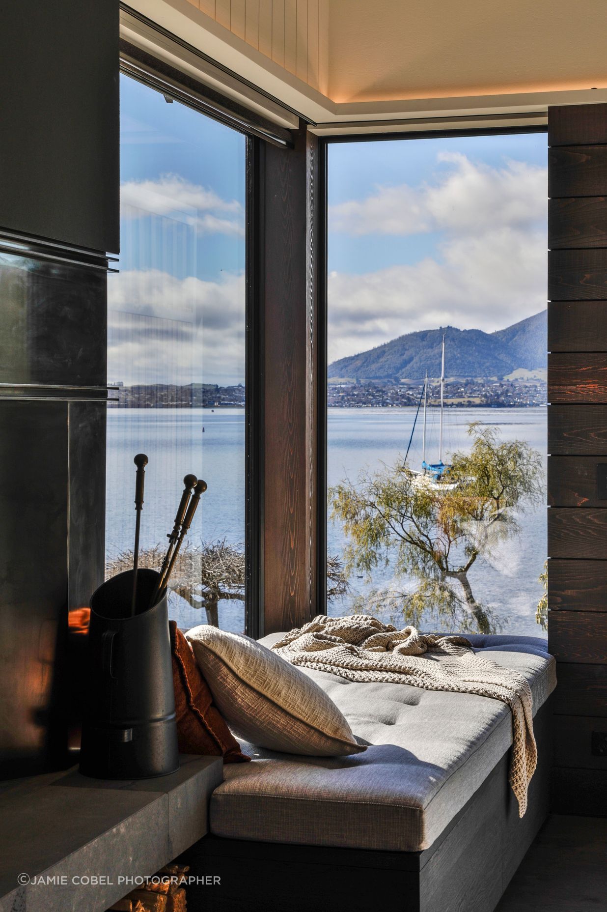 Next to the living room fireplace, the homeowners can retreat to the window seat to take in the view.