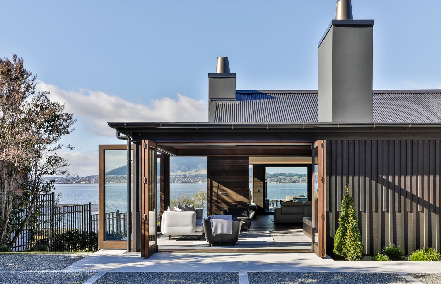 Arriving at the home, the workmanship is immediately evident. Vertical cedar battens pair with timber joinery, with timber continuing to the interior.