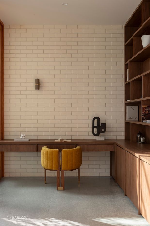 Brick pairs with bespoke cabinetry in the study.