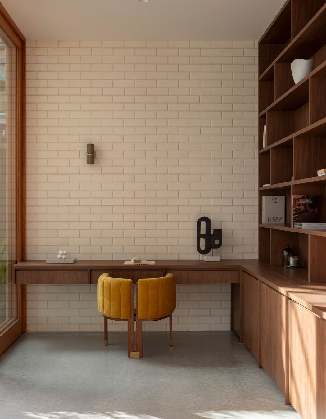 Brick pairs with bespoke cabinetry in the study.