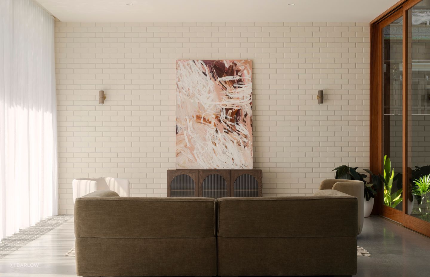 The lounge area enjoys natural light from the atrium and the north-facing floor-to-ceiling glazing.