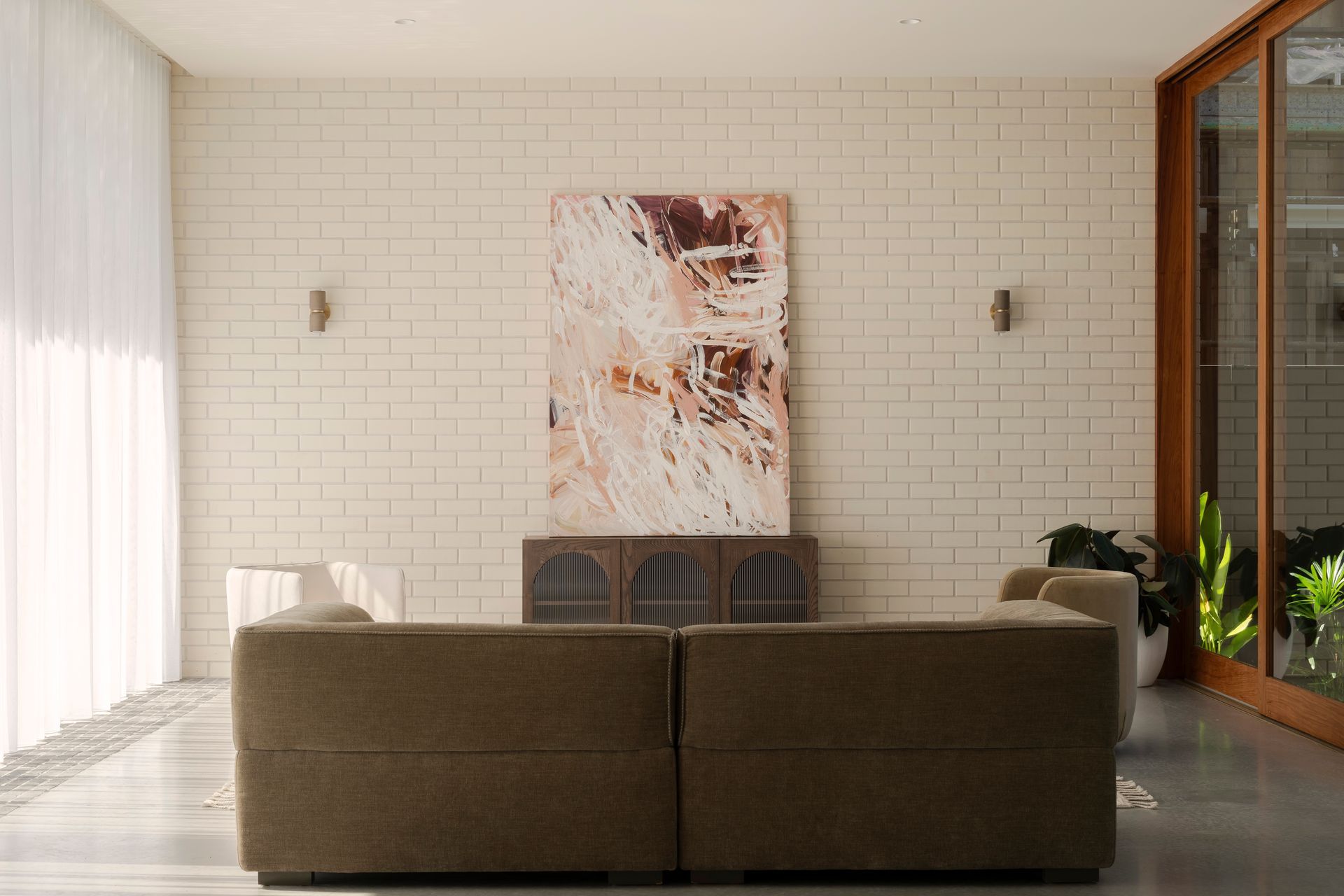 The lounge area enjoys natural light from the atrium and the north-facing floor-to-ceiling glazing.