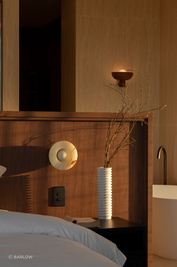 The master is warm and textural with a beautiful material selection.