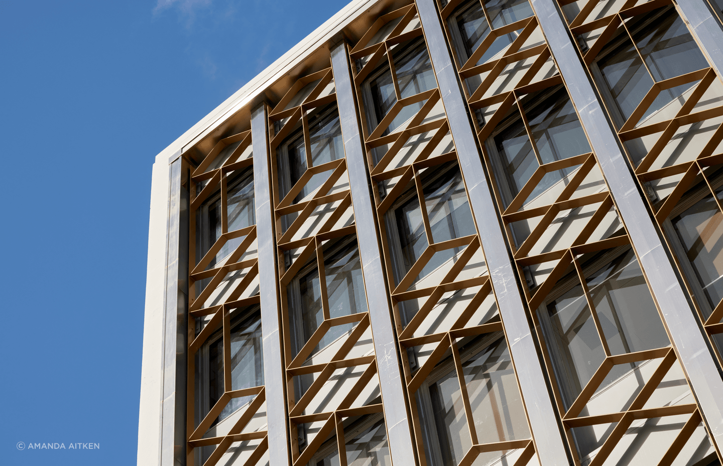 The facade treatment slots neatly with the existing steel fins on the exterior of the building.