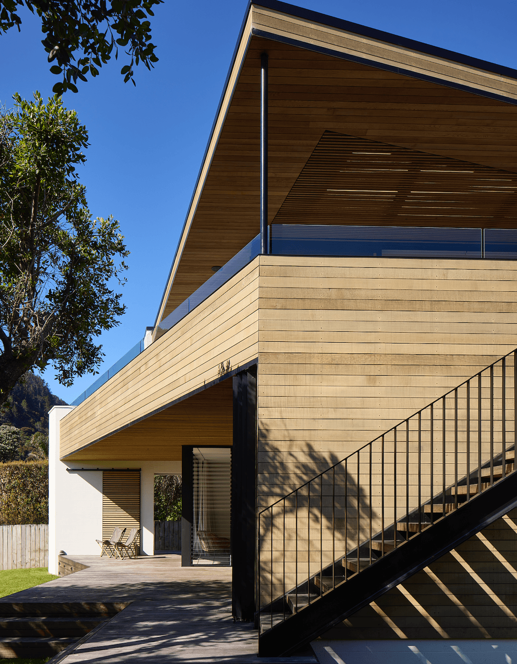 The wide eaves splay out in a variety of angles, echoing the silhouette of the adjacent hillside.