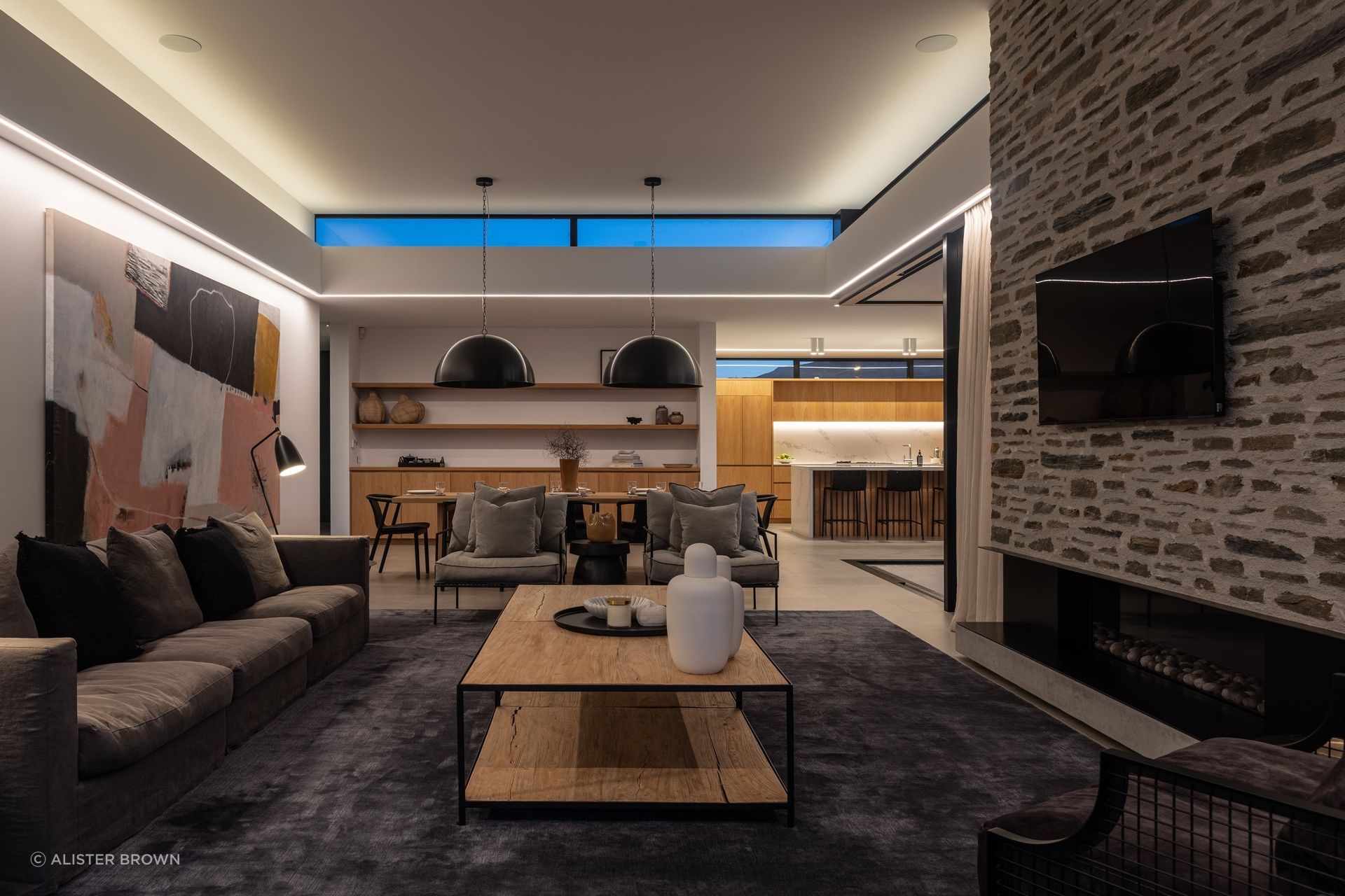 Upstairs, on the third level, a tranquil living, kitchen and dining area, courtyard, and guest room await. 