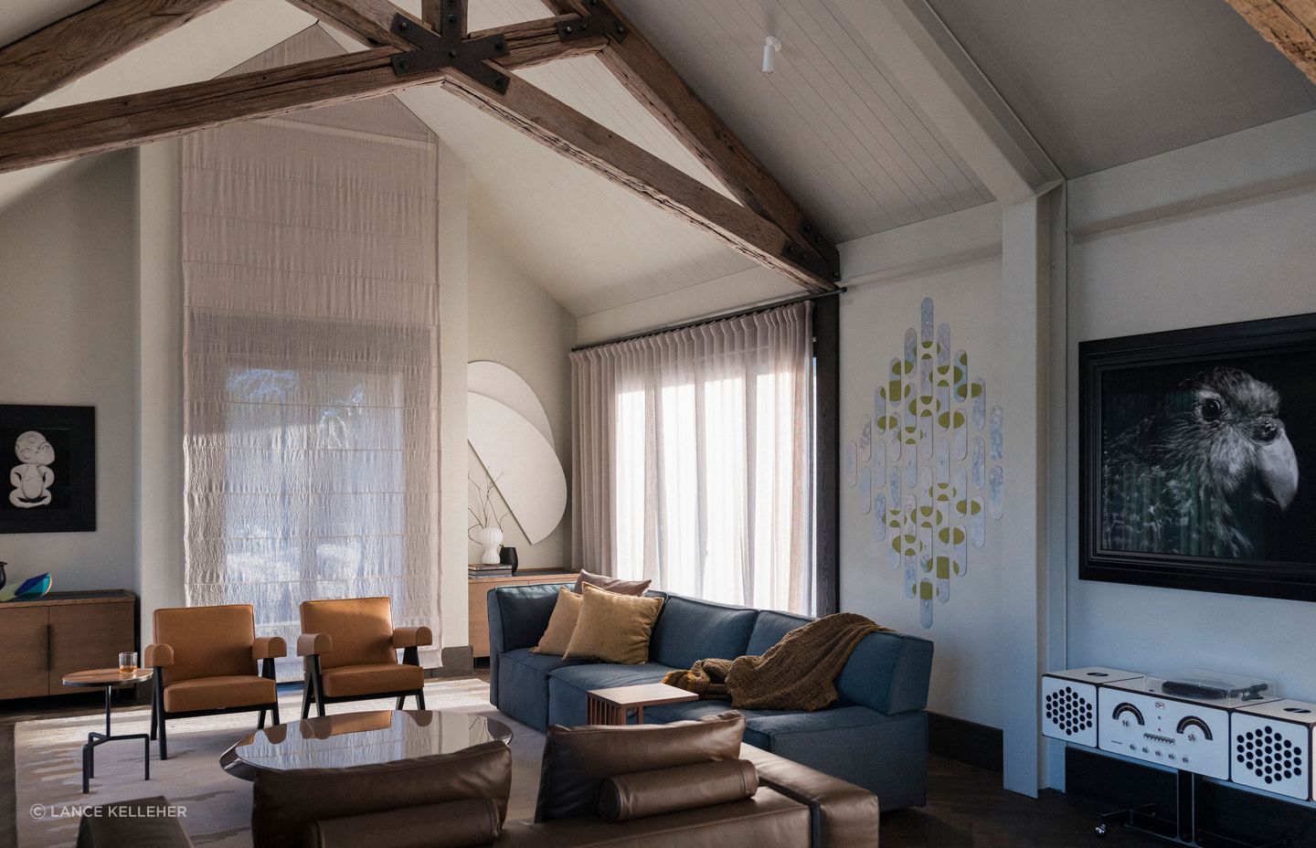 In the interior, a central fireplace was removed and rebuilt on the side of the space, to allow light in and blank walls to showcase the couple's many artworks.