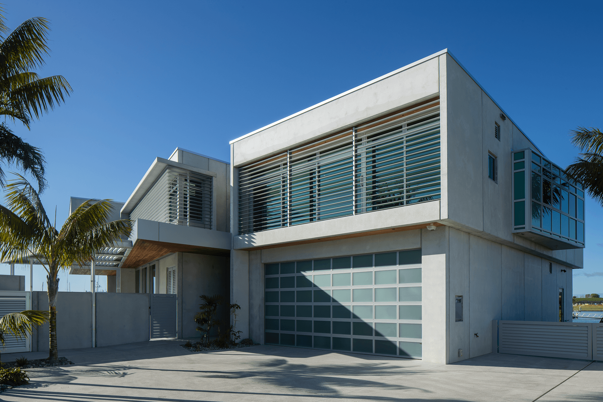 The building has a pared-back materiality of concrete, aluminium and stainless steel with accents of cedar.