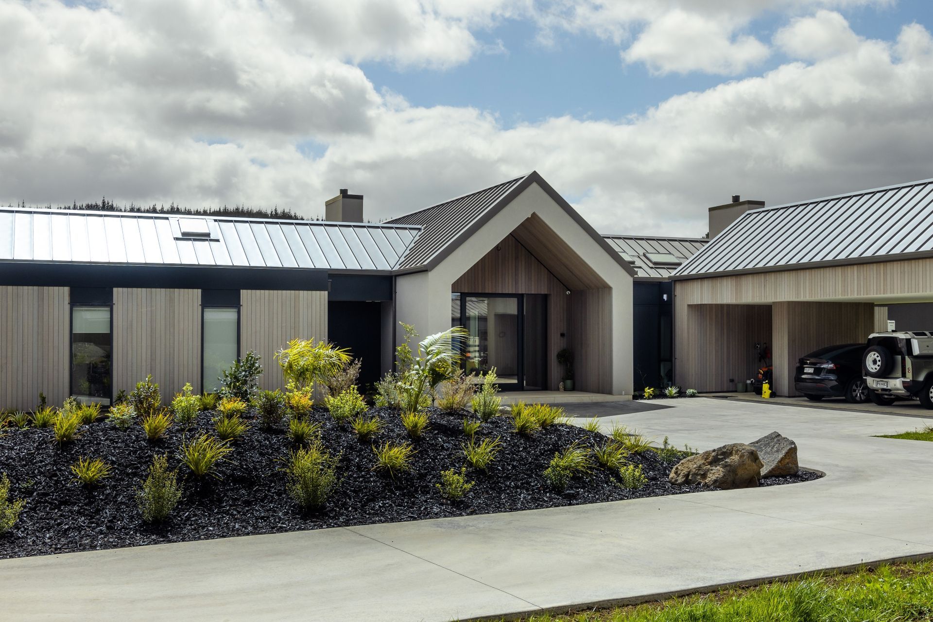 The entry to the homes is neatly recessed into a central gable form, creating a sheltered space.