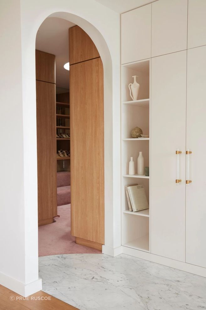 Pastel pink continues into the walk-in-wardrobe.