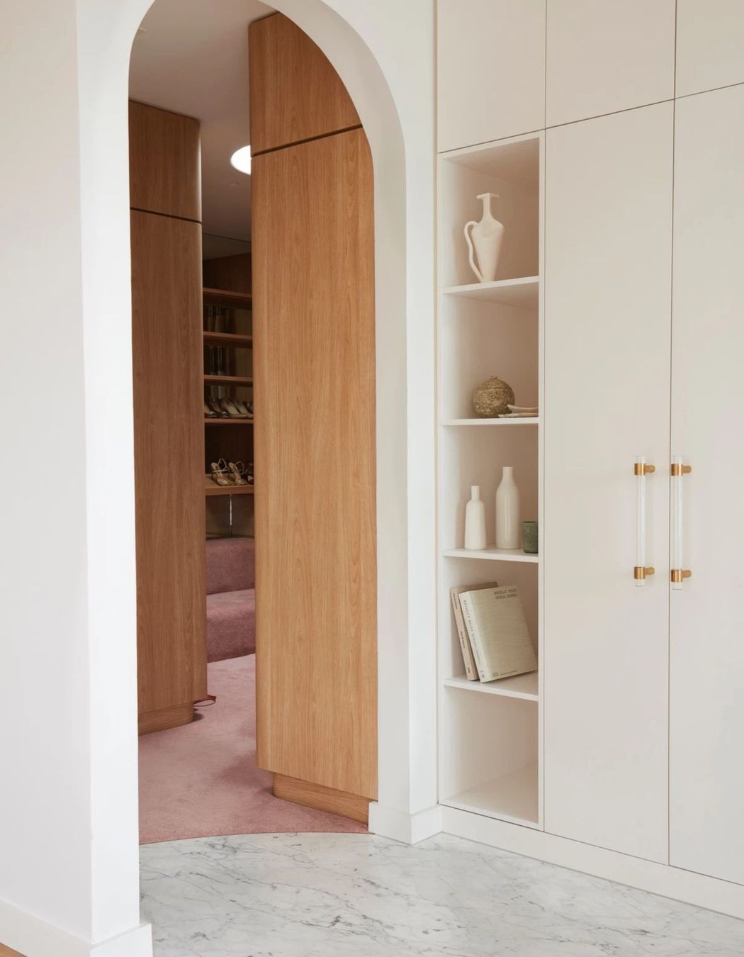 Pastel pink continues into the walk-in-wardrobe.