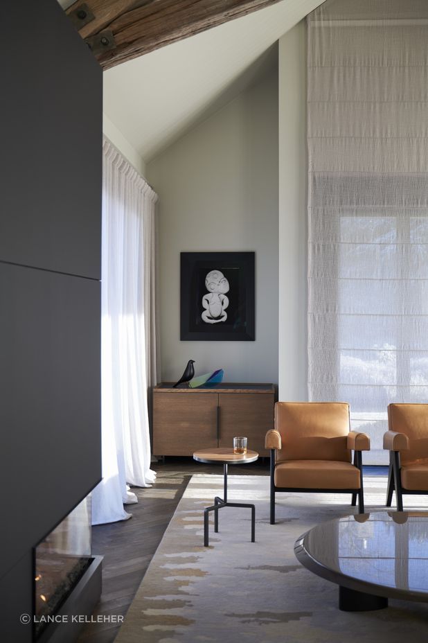 The new fireplace on the left; soft linen drapes soften the light coming in; and a rug called 'Pike' that is a part of a collection Anna-Carin designed herself, which references a fish her dad used to catch in the lake where she spent her childhood.