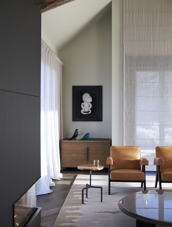 The new fireplace on the left; soft linen drapes soften the light coming in; and a rug called 'Pike' that is a part of a collection Anna-Carin designed herself, which references a fish her dad used to catch in the lake where she spent her childhood.