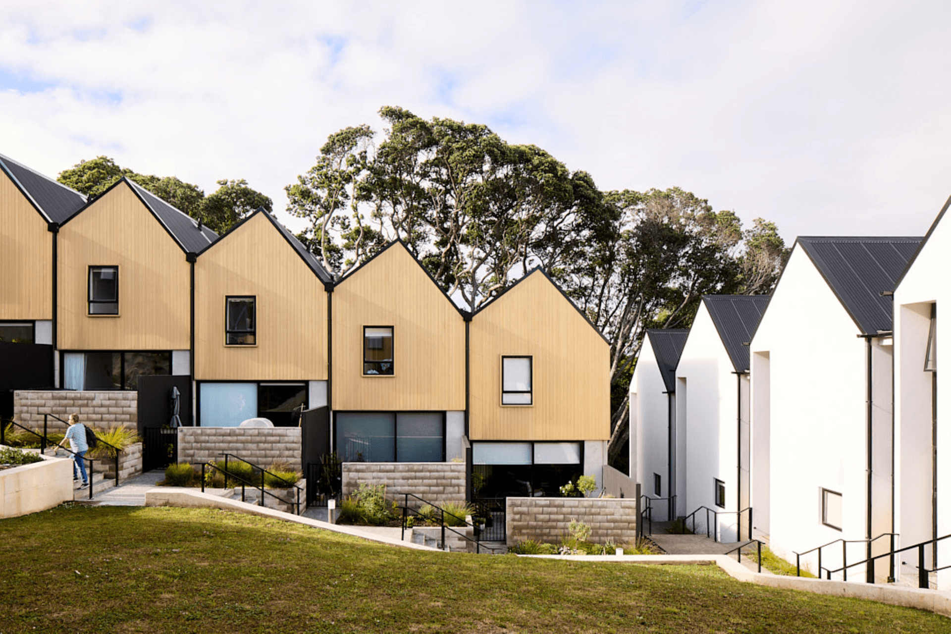 Terraced townhouses step down the site, and feature an asymmetrical roof pitch.