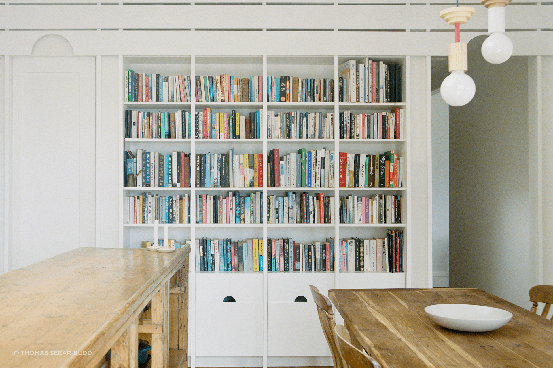 The repeated semicircle cut-out features on the built-in bookshelf.