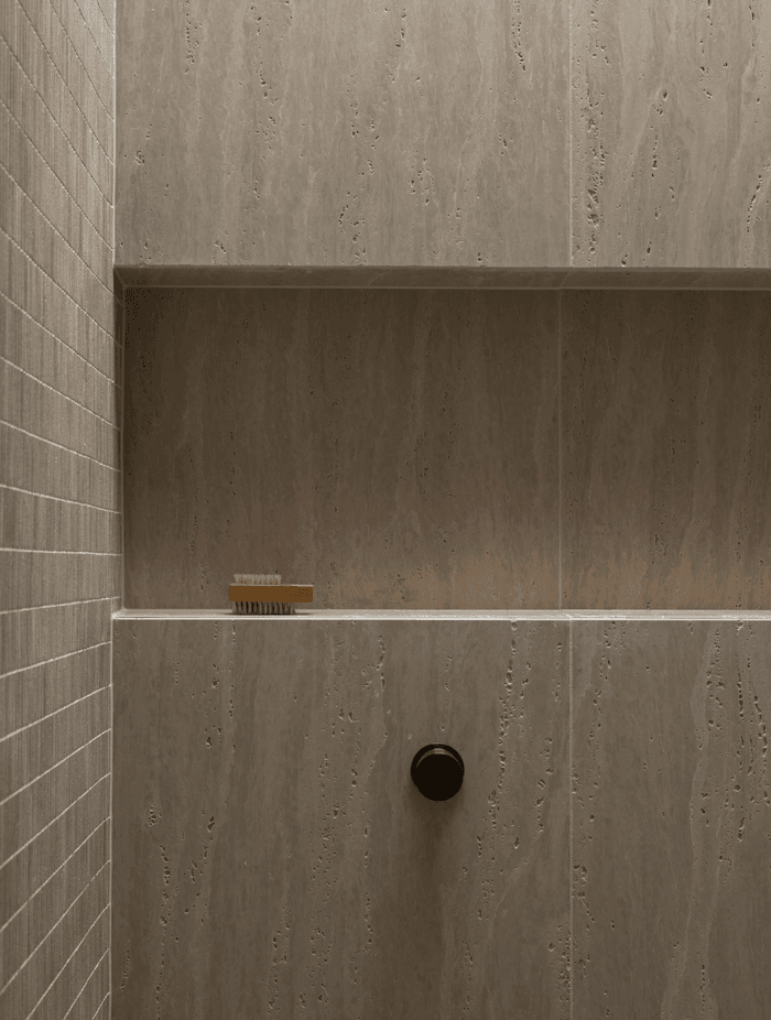 Beautiful and textural, the neutral tiles add sophistication to the small space.