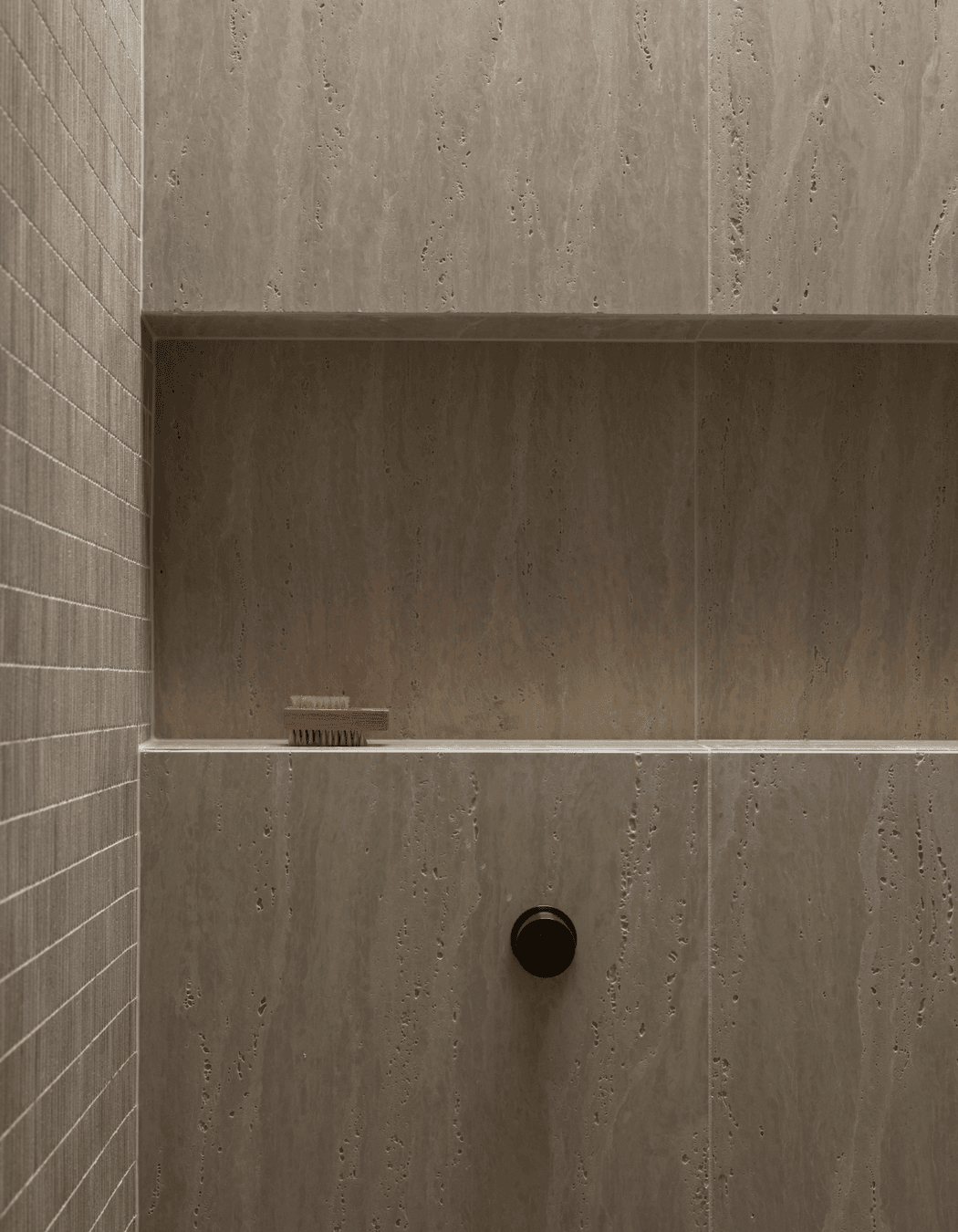 Beautiful and textural, the neutral tiles add sophistication to the small space.