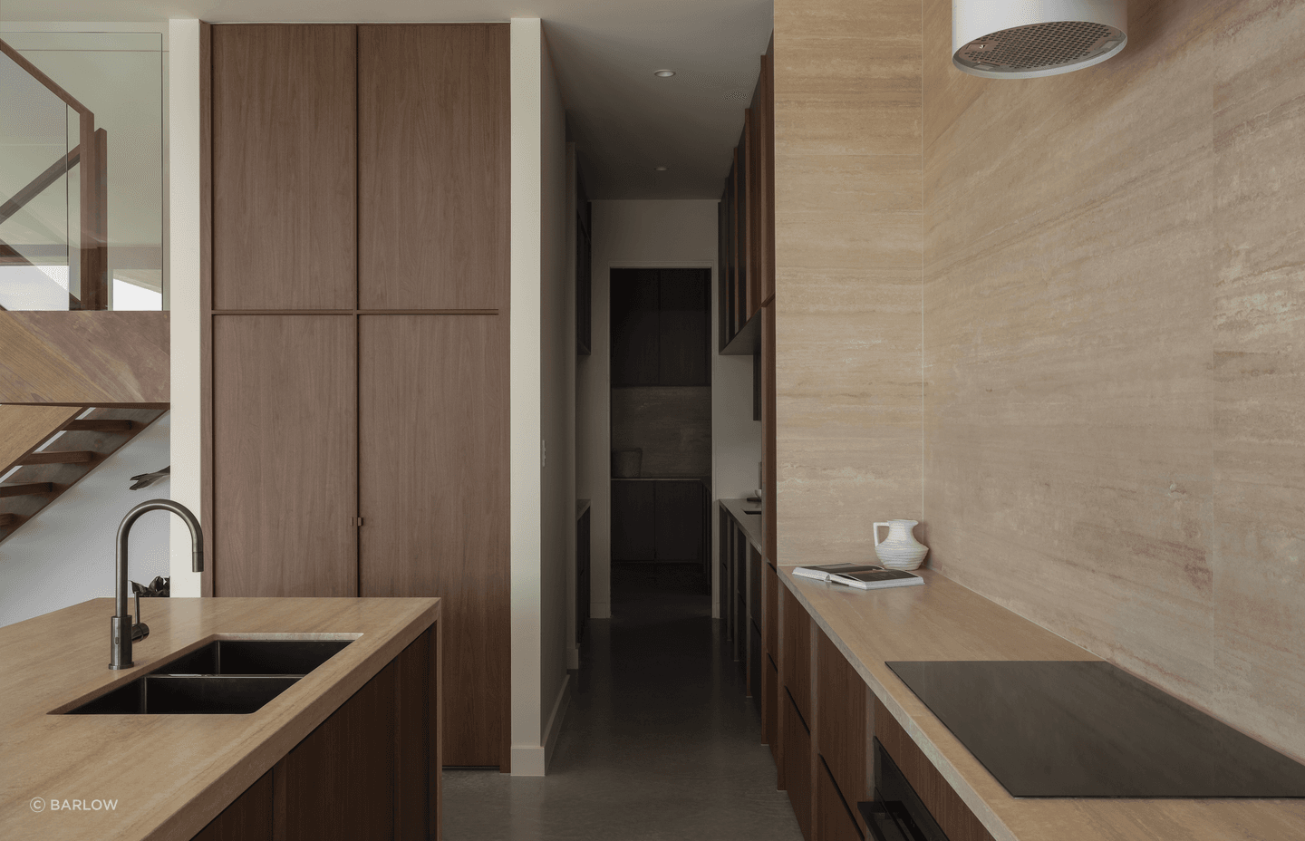 Chocolate-coloured timber cabinetry brings warmth to the kitchen, complete with a butler's pantry.