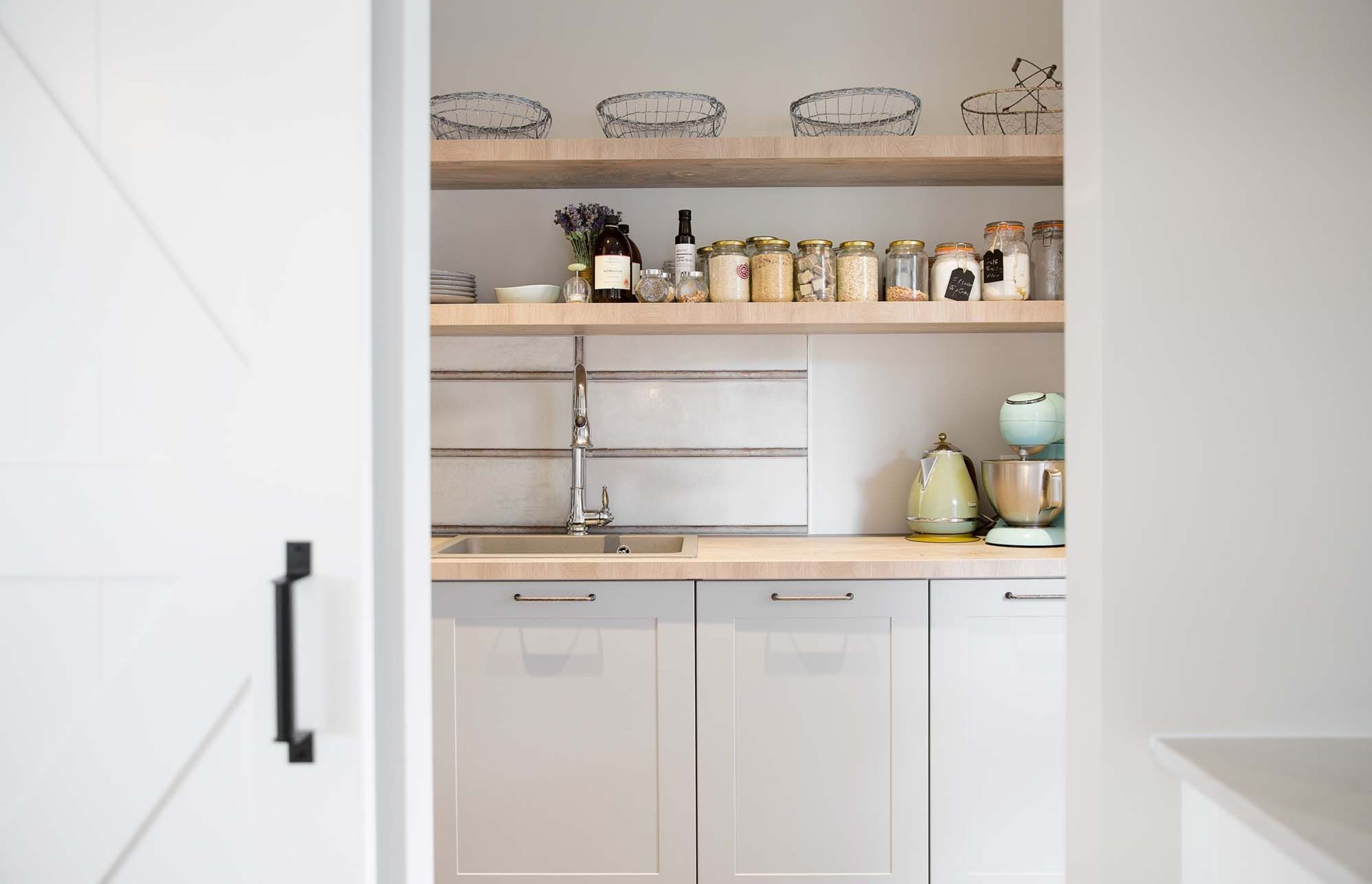 A stylish scullery with open shelving from Hacker Kitchens.
