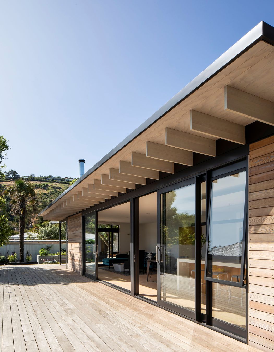 The low-profile roof is punctuated by slimline 'beams' which add a vertical element to the otherwise horizontal lines.