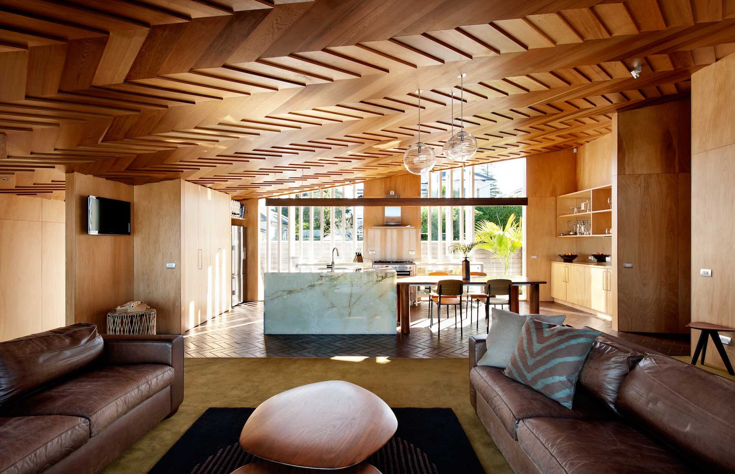 The warm and creative timber furniture and ceiling in the Wood Family Home, Auckland, was constructed by the client and the architect.