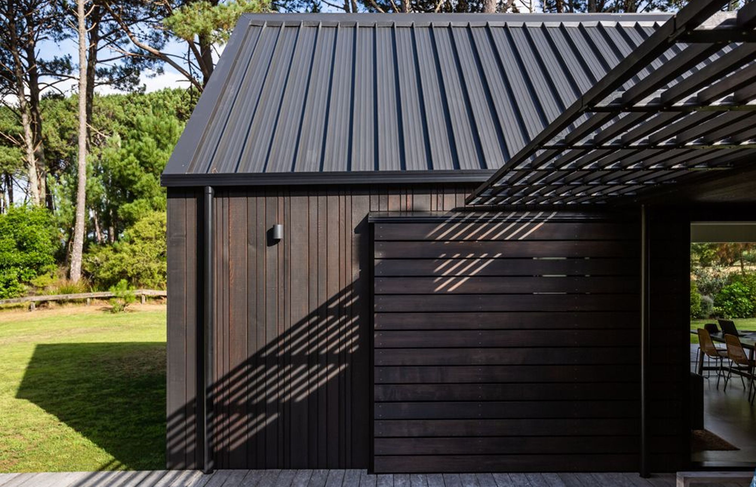 The 45-degree pitched roofs are a literal response to cabins in the woods. They are very clipped; there are no eaves yet the materials create a refined feel.