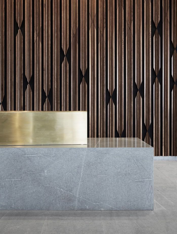 Timber panelling creates a warm backdrop to the hard reception desk.
