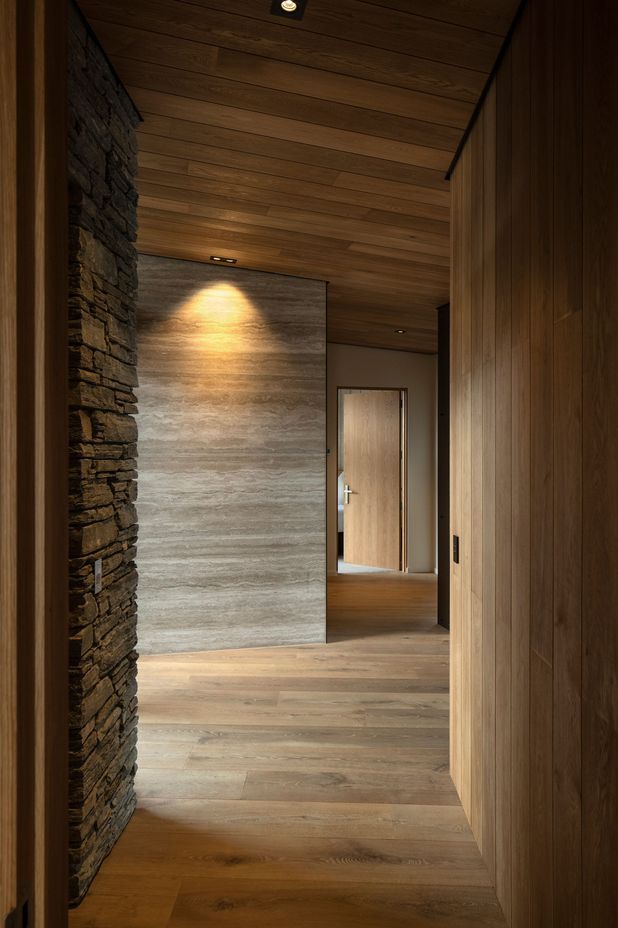 The hallway features oak, schist and travertine.