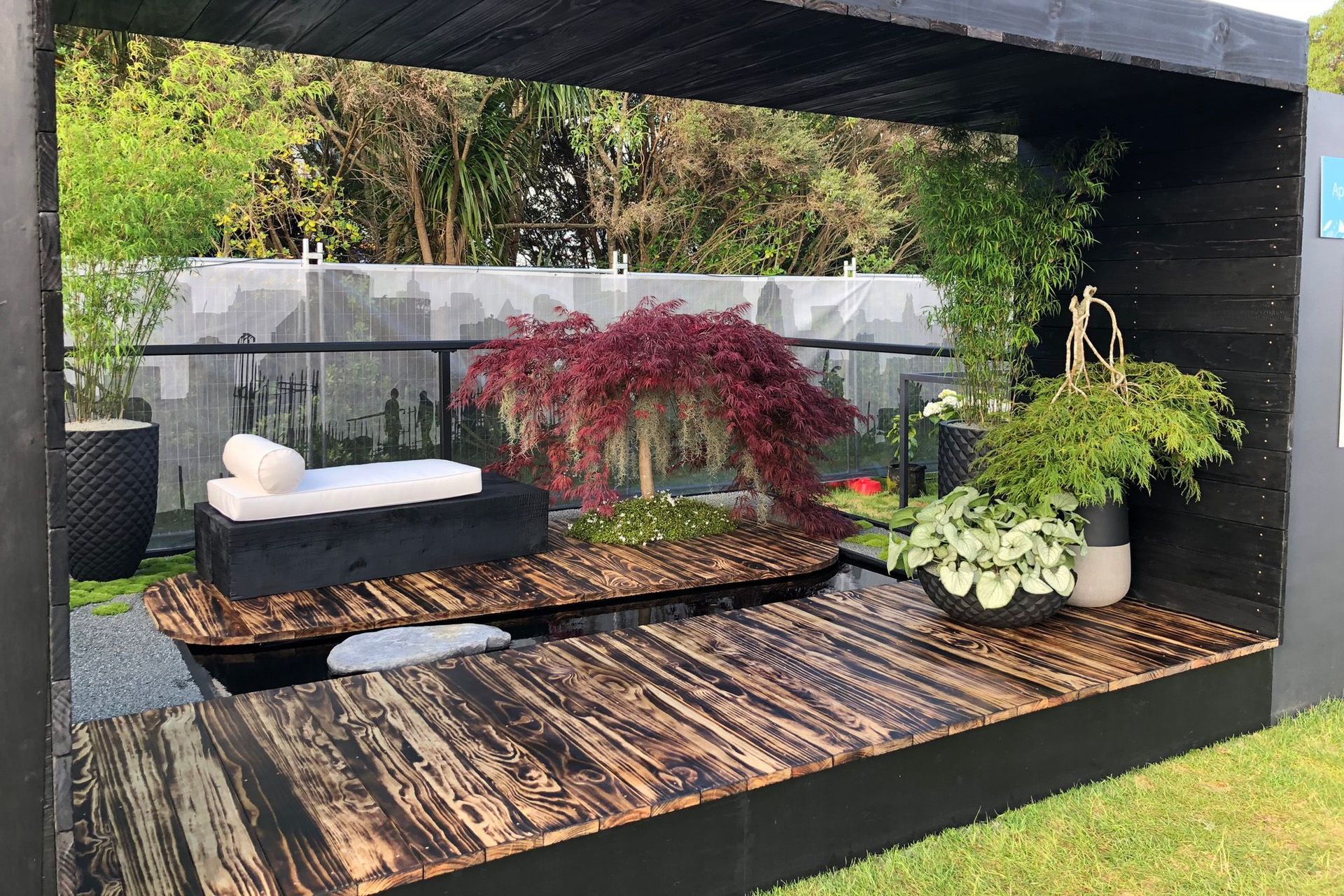 This urban oasis by Industry Landscapes has Asian-inspired elements bring a Zen-like influence to the space.. An ancient Japanese wood preservation technique is applied to multiple surfaces to create textural beauty.