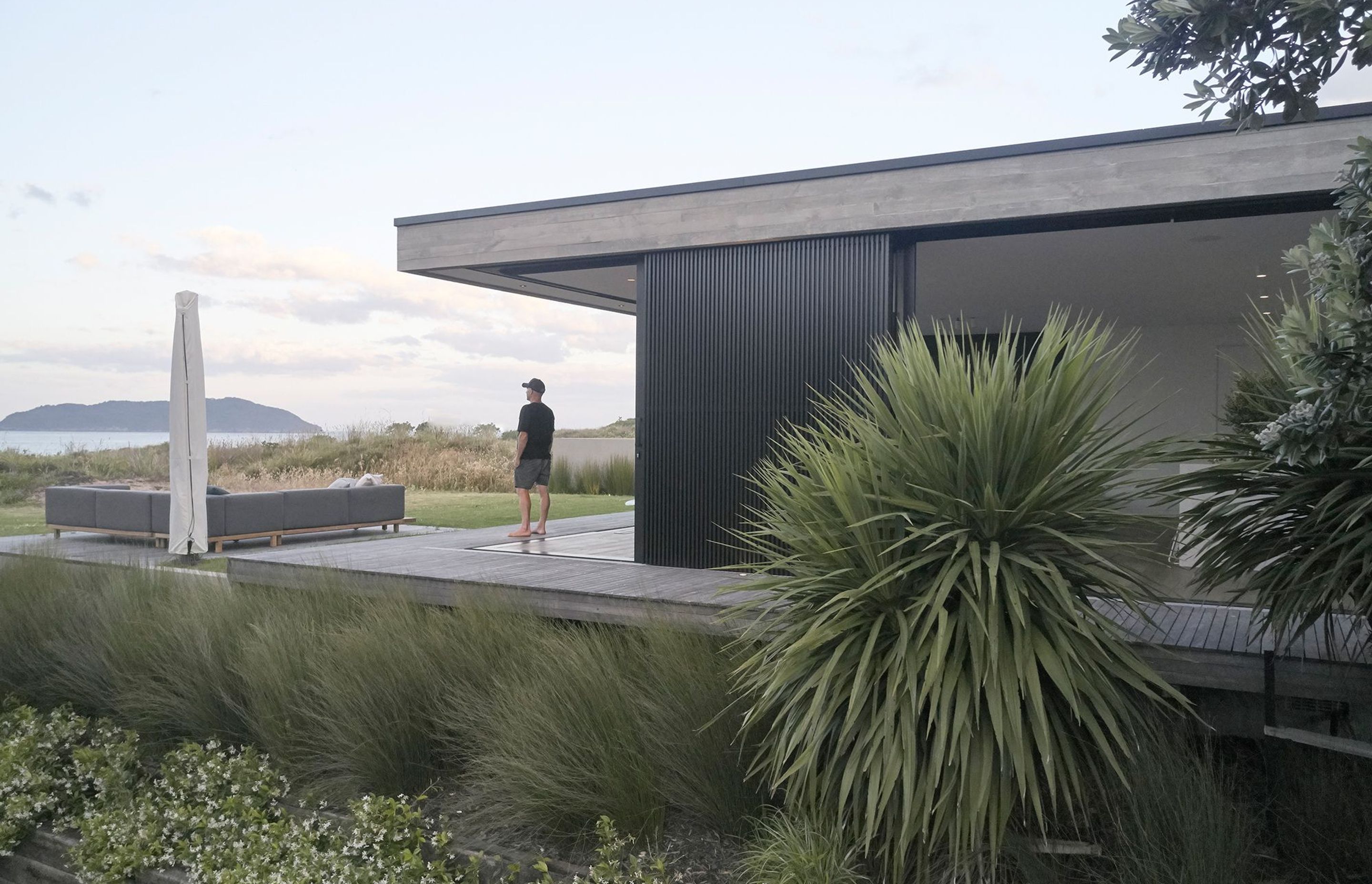 Adjacent to the dining area, a floating deck disconnected from the house sits in the grass, close enough to the dunes that the feeling of being within them is inescapable.