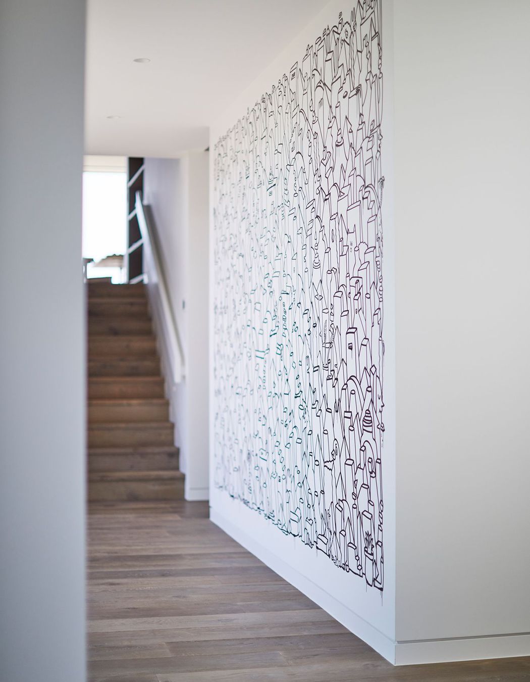 The informal entry into the house is on the second level, where stairs lead up to the main open plan living area.