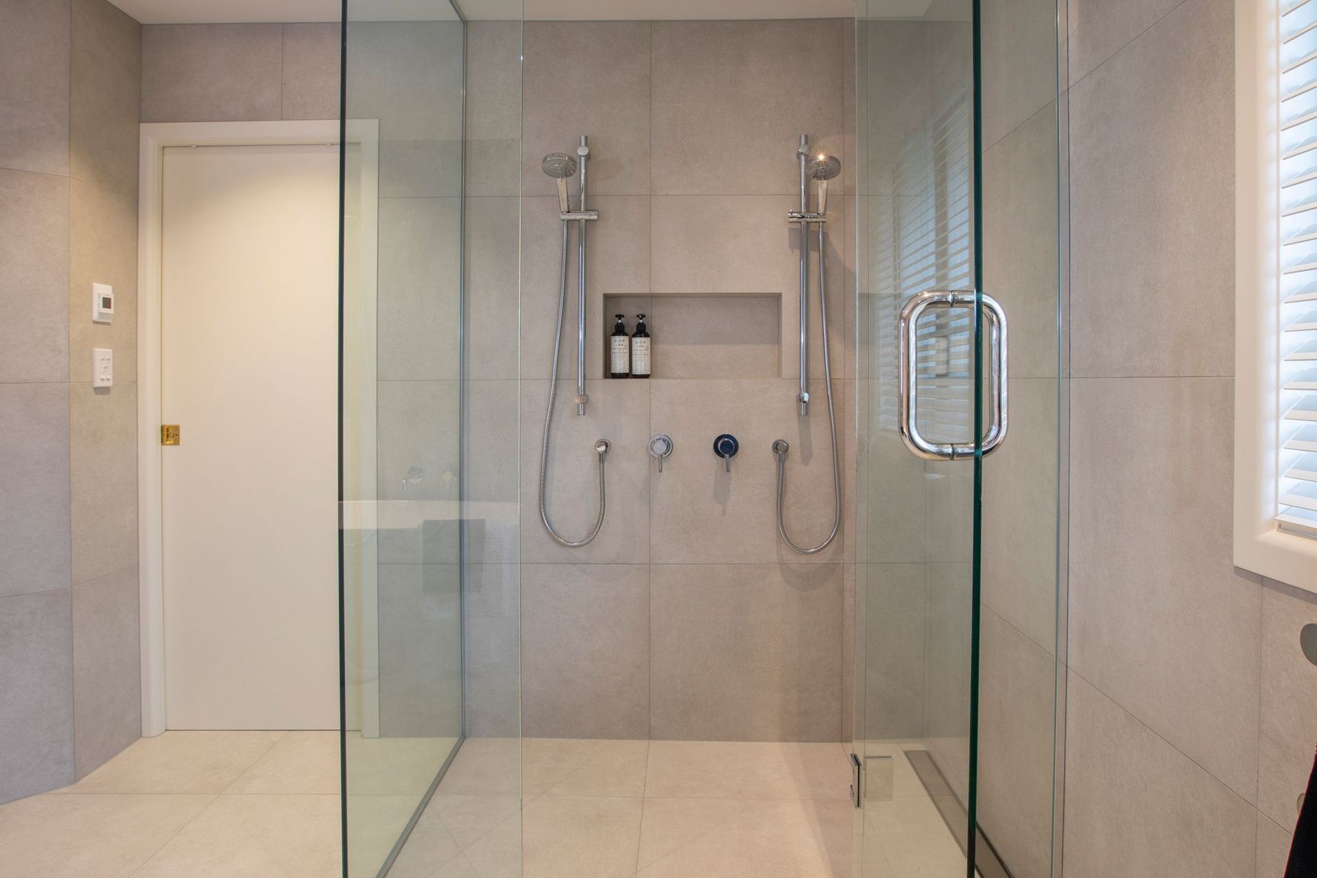 Large custom shower for maximum useability and practicality with the addition of a tiled recess shelf.