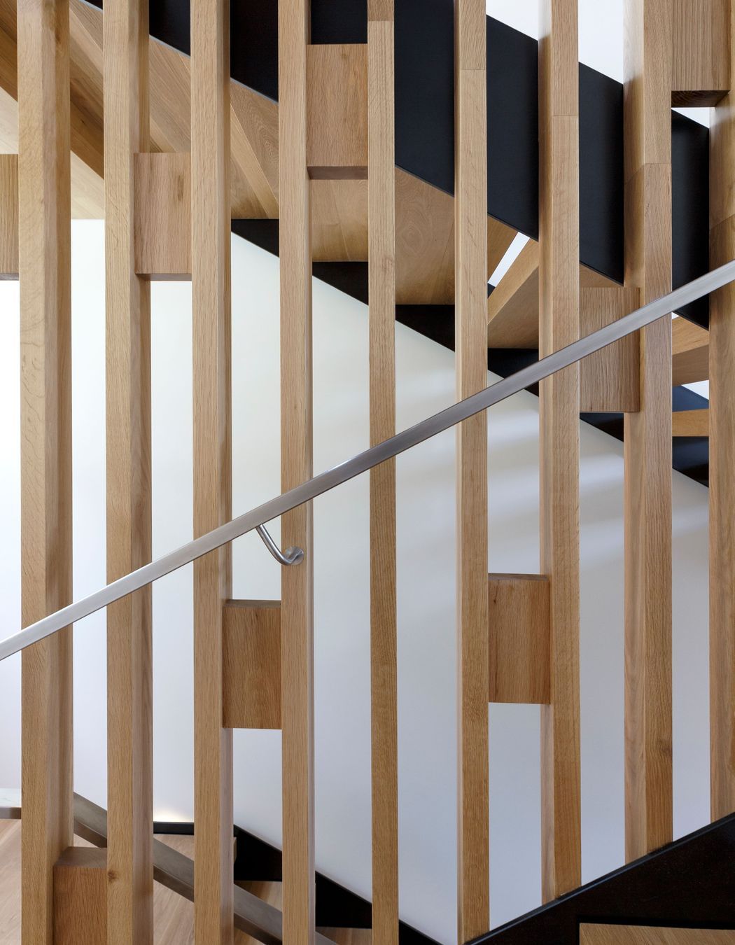 Timber blocks add bracing and pattern to the balustrade of the staircase.