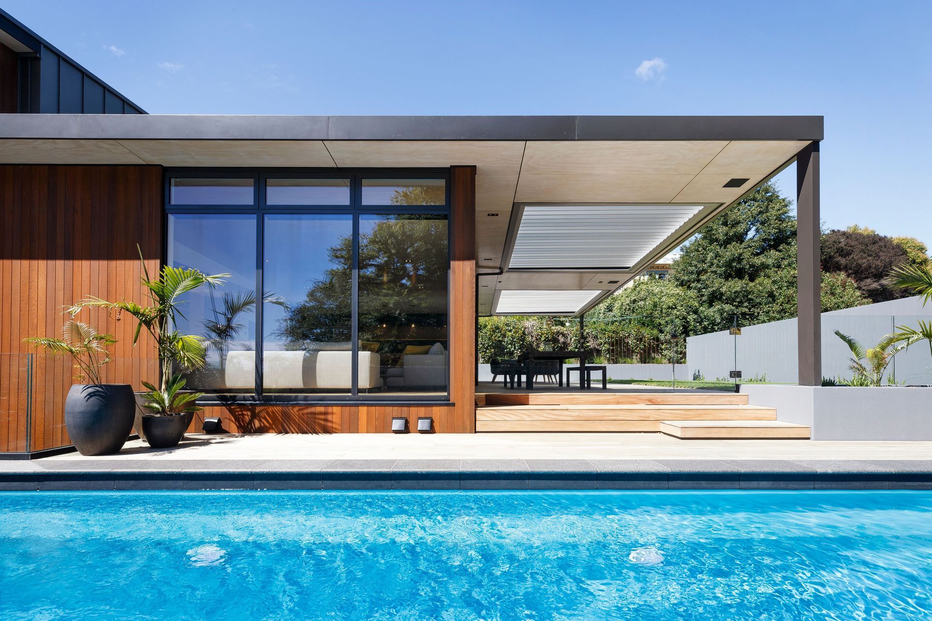 The lounge and outdoor dining area viewed from the pool.